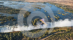 Tourists fly over the Victoria Falls on the trikes.